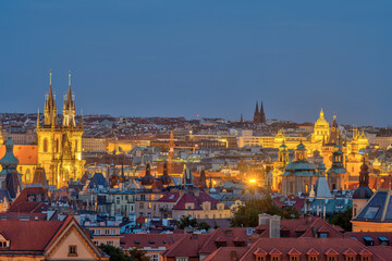 View over the old town of Prague at night with the towers of the Tyn Church 