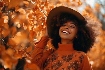 Beautiful smiling black woman walking in the park with autumn leaves, fashion