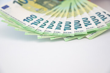 Closeup of hundred Euro banknotes on the table . Loan,salary,savings,cost of living,busines concept.Selective focus
