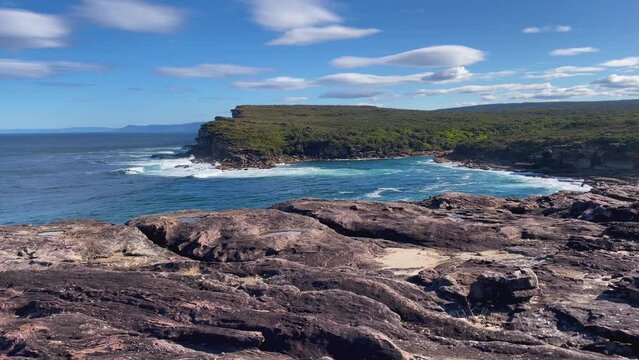 4k Video -Spectacular sandstone coastline in Royal National Park, NSW, Australia. View of Curracurrang Gully where fresh water meets the ocean's salt water.