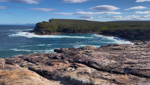 4k Video -Spectacular sandstone coastline in Royal National Park, NSW, Australia. View of Curracurrang Gully where fresh water meets the ocean's salt water.