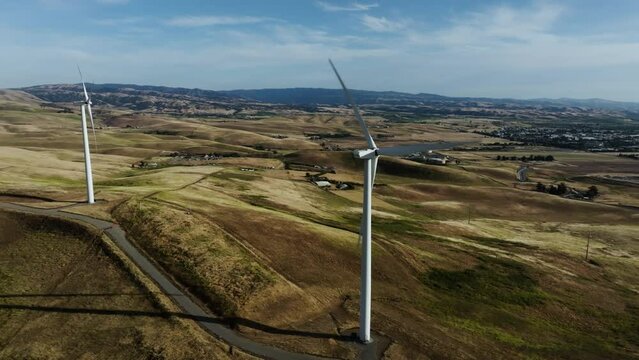 Aerial view orbiting a eolic wind turbine in the mountains of San francisco, USA