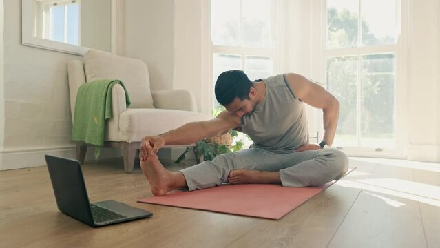 Man, yoga and stretching on computer for home training, fitness and holistic or wellness in virtual class or video streaming. Young person on floor for workout, exercise and muscle health on laptop