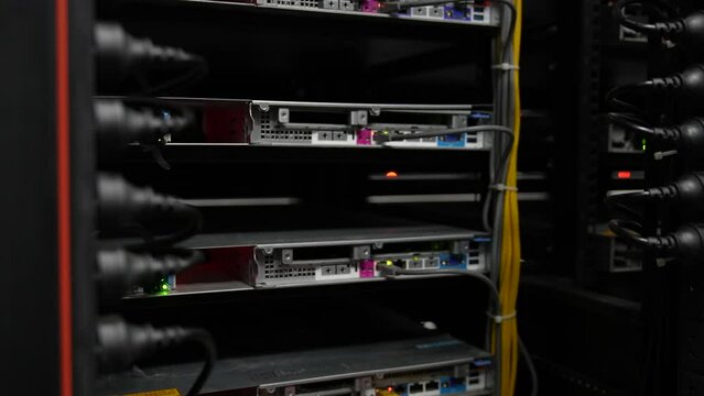 Servers like these are used for cloud computing, Data Center With Multiple Rows of Fully Operational Server Racks.