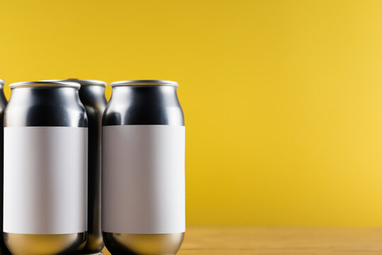 Cans of soda with yellow background