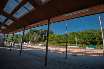 Modernised train station of Rimske toplice, close to Lasko, Slovenia on a summer day. Visible platform and shade next to the station building.