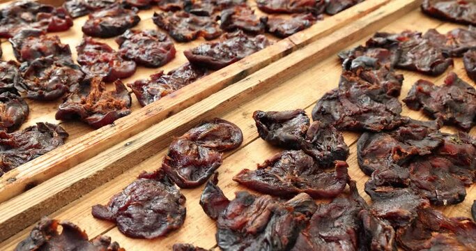 Beef jerky on a wooden board closeup. Drying is type of cold drying of organic products