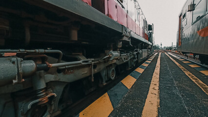 Large Bogies of a Railroad Locomotive At A Station