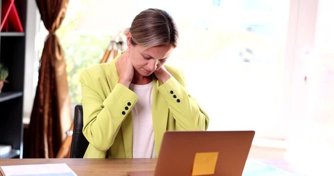 Pinched nerves tight muscles and fibromyalgia due to sedentary lifestyle. Incorrect posture and woman touches neck and feels pain