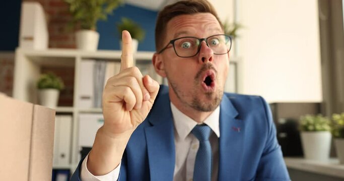 Excited surprised happy man businessman thumbs up having great idea at workplace in office. Creative ideas for business