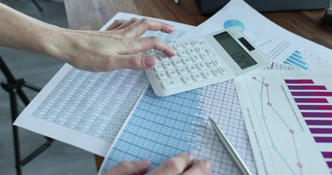 Marketing manager clicks on calculator to calculate bills in report. Business analytics and statistics