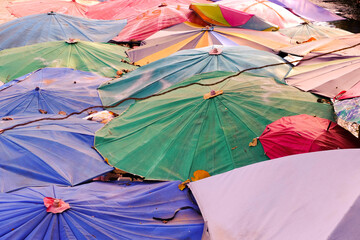 Colorful umbrellas by the stream