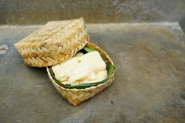 fermented cassava in a basket on a concrete background