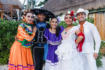 group of mexican dancers wearing traditional folk costume, portrait of young latin people in Mexico...
