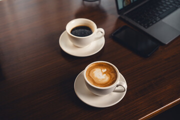 Coffee on the desk in the morning