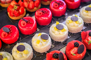 Selection of delicate petit four desserts on display at an artisanal bakery cafe in the old town or...