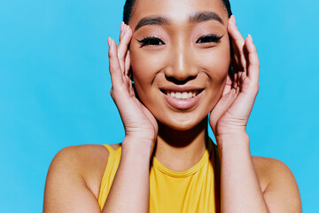 Lifestyle woman wow pretty beauty smile surprised trendy yellow portrait face mouth blue fashion