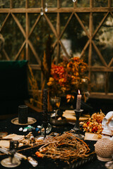 Halloween party decor in gloomy dark colors with the table is set