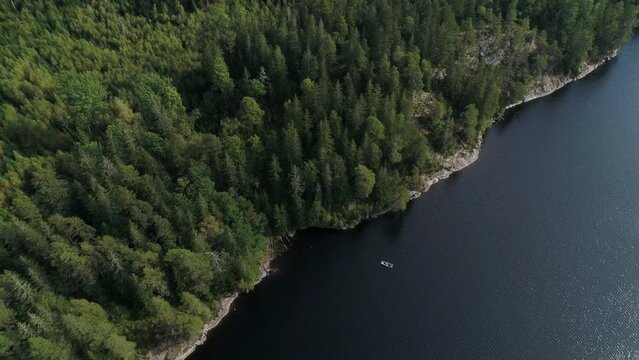 50fps aerial footage couple Kayaking Boat tour on lake Ragnerudssjoen in Dalsland Sweden beutiful nature forest pinetree