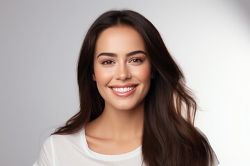 Closeup photo portrait of a beautiful young latin hispanic model woman smiling with clean teeth. Used for a dental ad. Isolated on light background. - obrazy, fototapety, plakaty