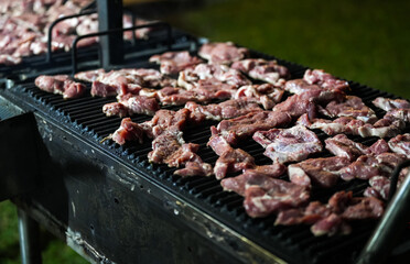 Pork barbecue. Close up photo with some pork neck meat on a charcoal grill cooked for an evening party. Meat grill barbecue.