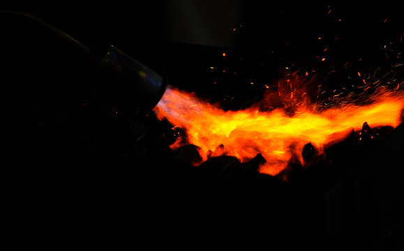 Charcoal lighter. A flame thrower used to light up the coals for a charcoal barbecue grill. Outdoor cooking tips. 