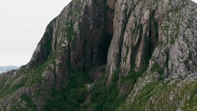 Drone reveal mystical Torghatten from dark hole through mountain
