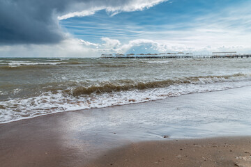 Storm in Issyk-Kul. View of the waves, pier and beach.
