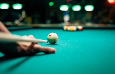 Preparing to break spheres into the pool pocket. People billiard, snooker entertainment concept.