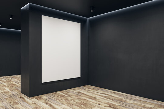 Modern black concrete gallery interior with wooden parquet flooring and blank white mock up poster on wall. Art and display concept. 3D Rendering.