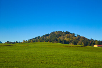 Looking out the window train moving through the German countryside near Fussen.