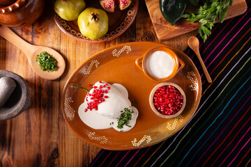 Chile en Nogada, Typical dish from Mexico. Prepared with poblano chili stuffed with meat and fruits and covered with a walnut sauce. Named as the quintessential Mexican dish for national holidays.