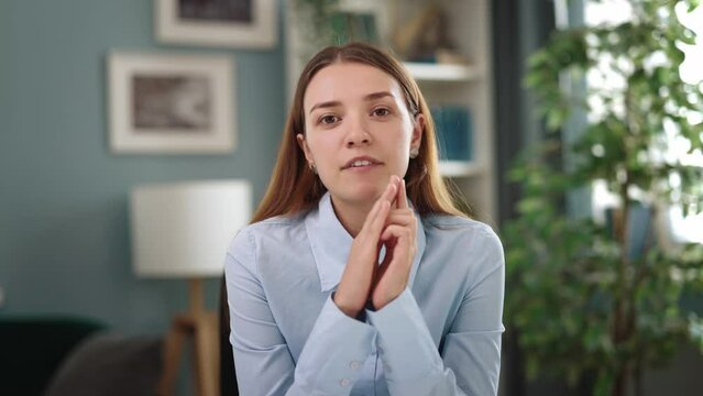 Cheerful young student woman wearing blue shirt use videochat from home, businesswoman has videoconference distantly online, first person view