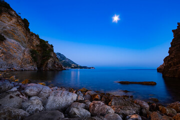 Fototapeta na wymiar seascape at night, sea, moon and rocky shore, beautiful seaside resort, beach, adriatic sea, summer vacation