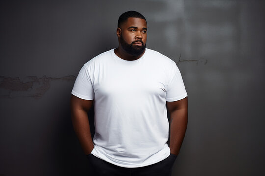 design mockup: black plus sized man wearing a blank white t-shirt, studio shot