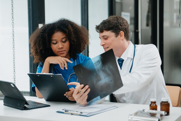 Obraz premium Medical technology network team meeting concept. Doctor hand working with smart phone modern digital tablet and laptop computer