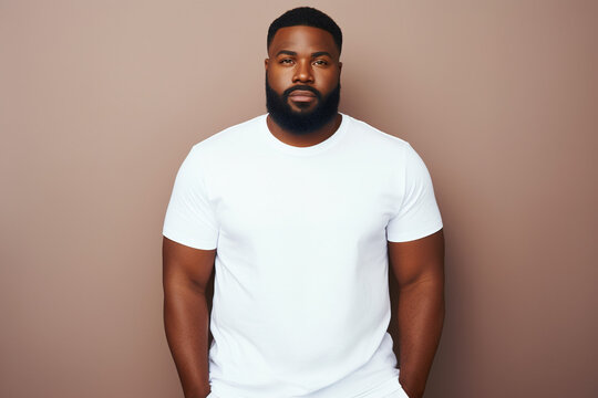 design mockup: black plus sized man wearing a blank white t-shirt, studio shot