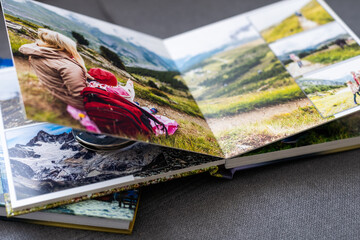 Family photos archive saved in brightly designed photo book; bright summer memories placed in the...