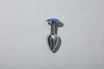 Metal anal plug on a white background.