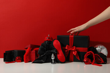 A collection of sex toys on a red background.