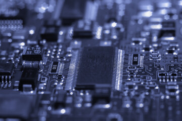 Intricate circuit board with computer hardware, showcasing complexity of electronics industry.