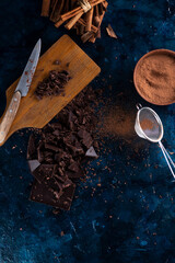 Pieces of chocolate and spices on the table