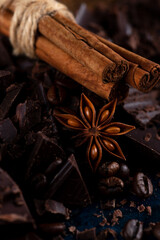 Pieces of chocolate and spices on the table