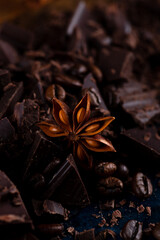 Pieces of chocolate and spices on the table