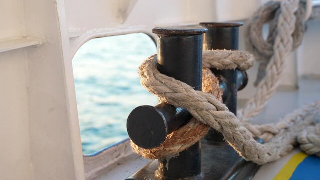 Close up of nautical rope with sailing knot on the bitts for boating and mooring vessel. 
