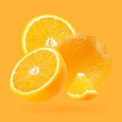 Bright oranges closeup levitation as art composition. Whole, half, piece fruits on pastel orange background with shadow. Tropical fruits for advertising, design, label product, poster, card.