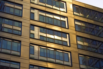 Fototapeta na wymiar Modern glass facade of skyscraper during sunrise.