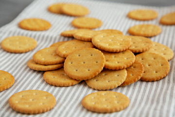 Round Crispy Crackers with Sea Salt on a gray background, low angle view.