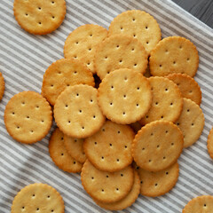 Round Crispy Crackers with Sea Salt on a gray background, top view.