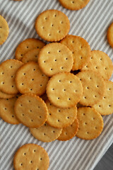 Round Crispy Crackers with Sea Salt on a gray background, top view.